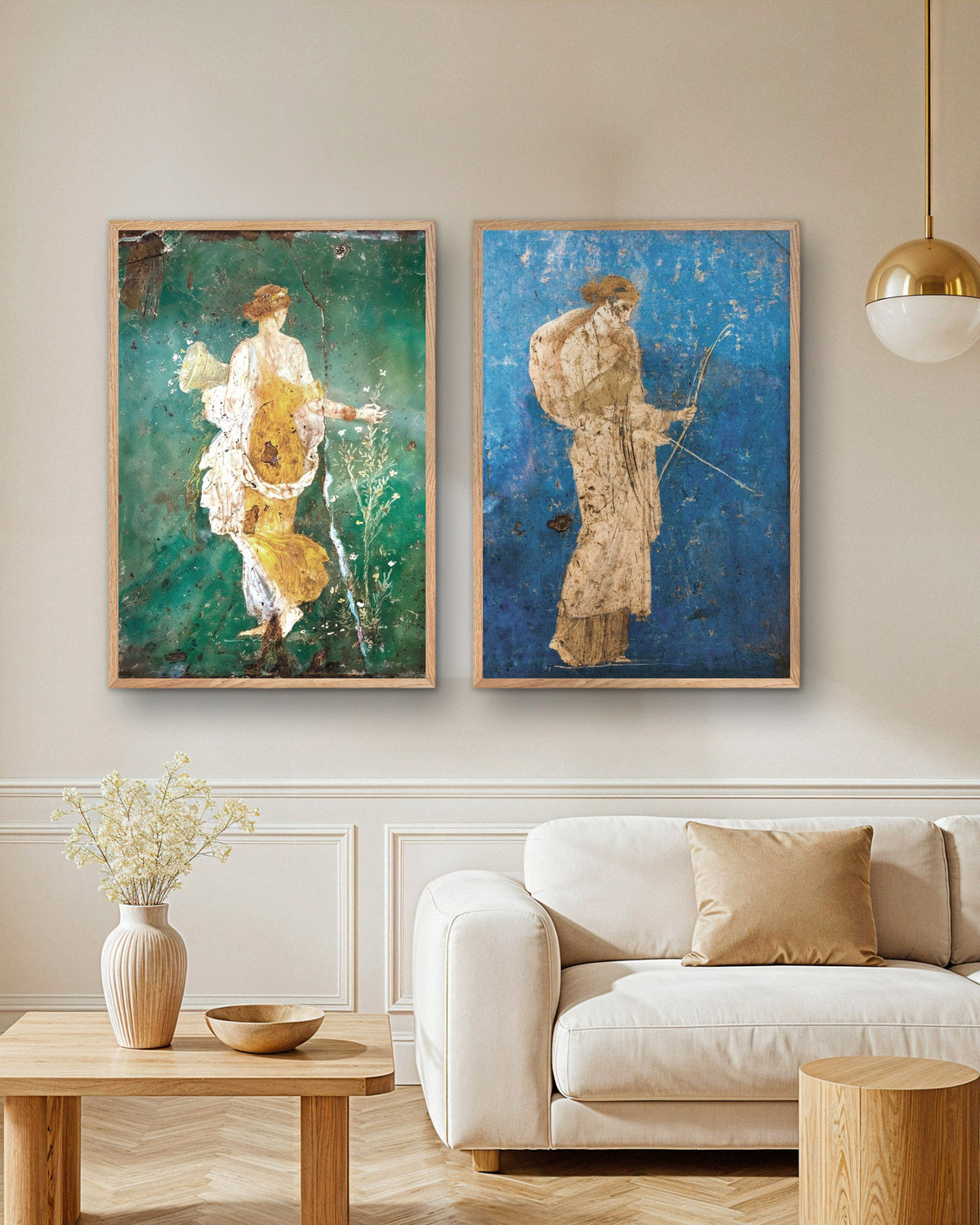 Set of 2 Roman fresco posters, Flora and Artemis, in natural wooden frames above a sofa in a living room